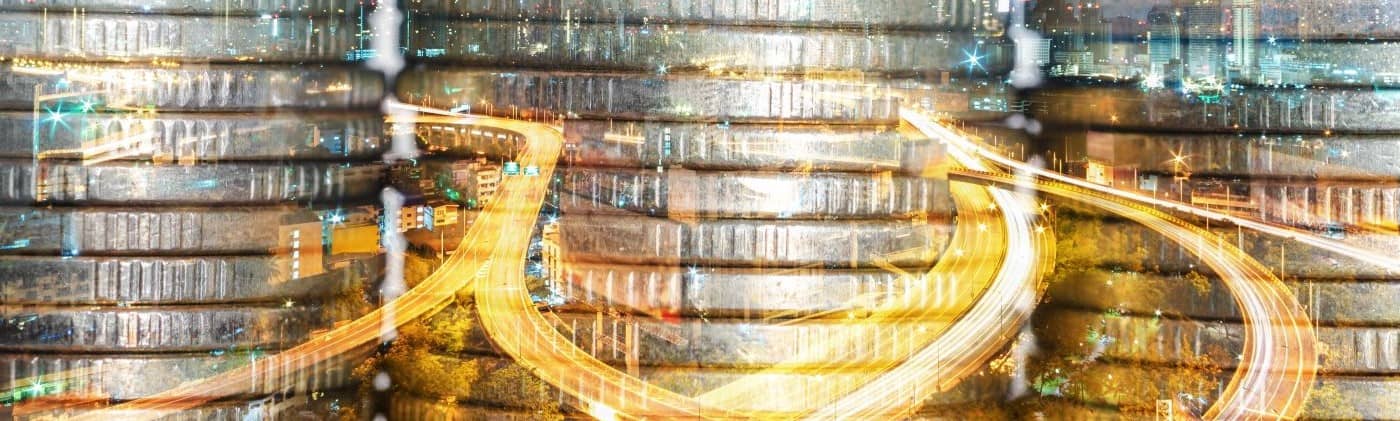 Stack of coins with financial graph over city