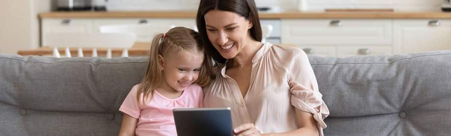 Mother and Daughter using Computer Tablet