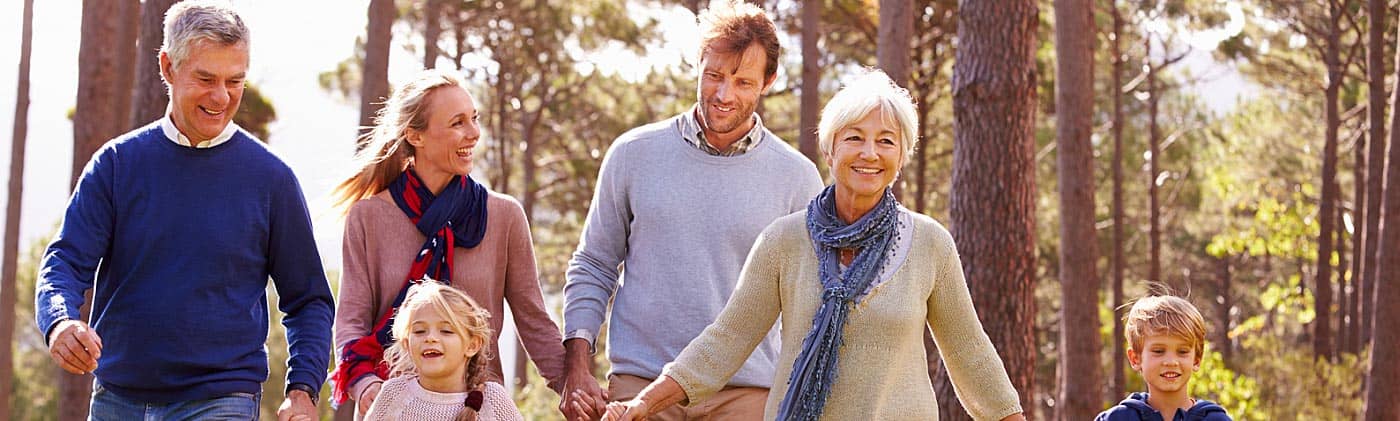 multigenerational family discusses avoiding common retirement mistakes on a fall walk in the woods
