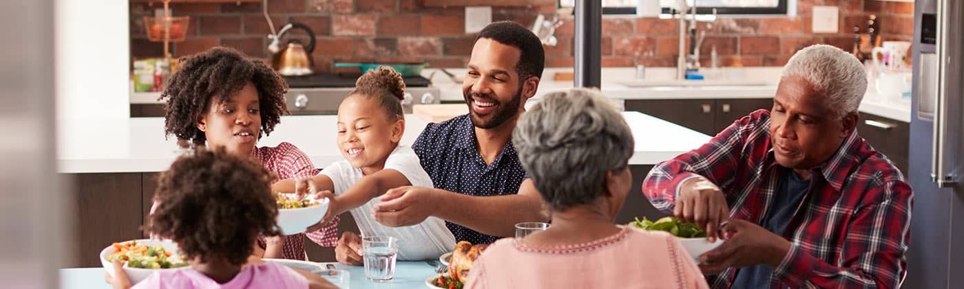 A multi-generational family spends time at home: caring for aging parents