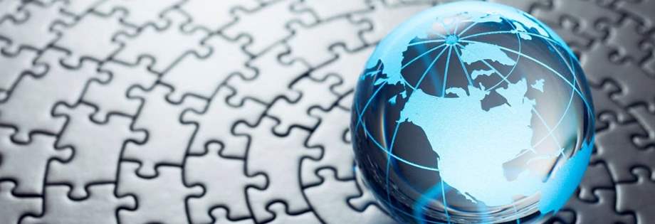 Photo of a glass globe on a circular puzzle.