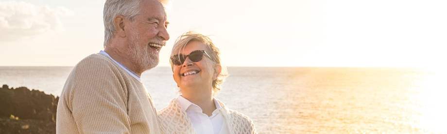 Retirees like this couple by a shore may wonder: Does Social Security increase with inflation? 