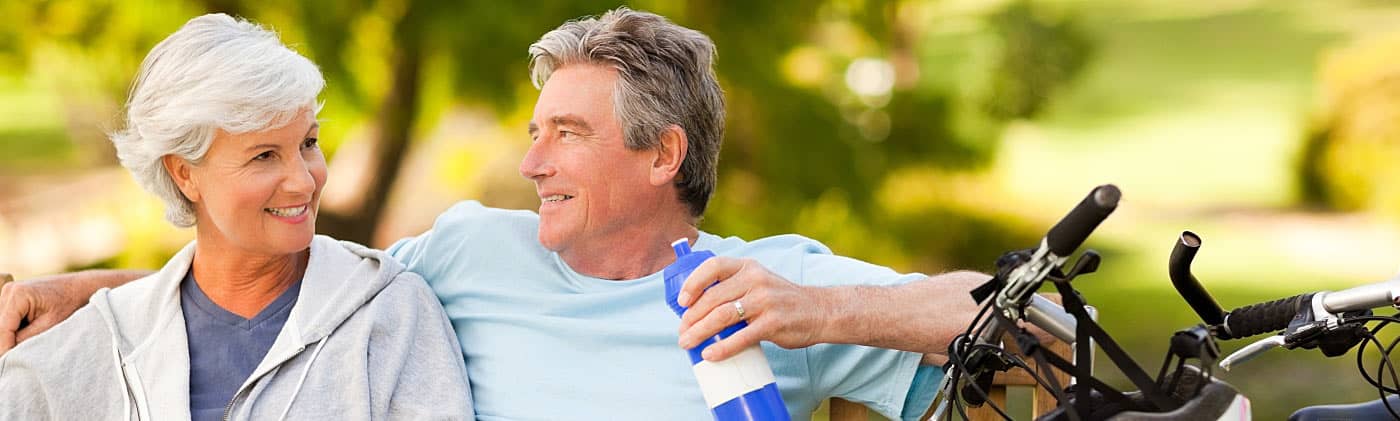 Older couple with bikes who are evaluating an early retirement offer 