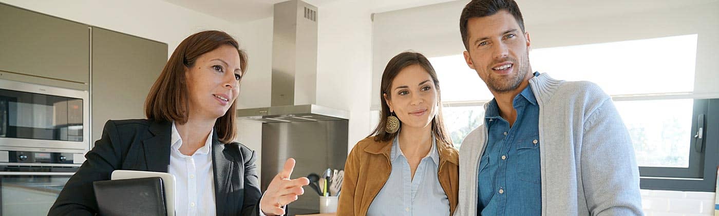 Real estate agent shows a home to a couple