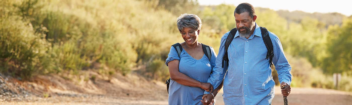 Retired couple hiking on a trial