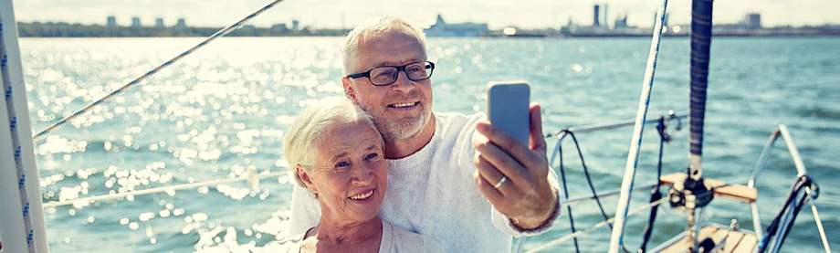 Retired couple taking a picture on a boat after they retired overseas 