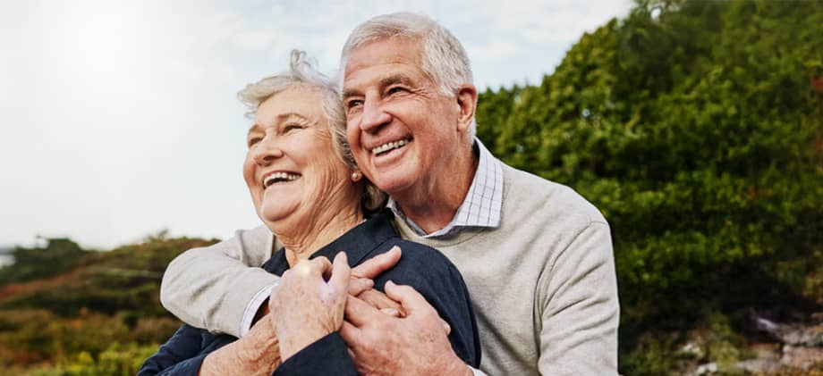 Couple embraces while enjoying retirement.