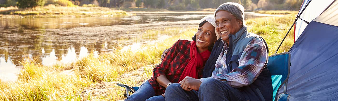 Senior couple on autumn camping trip discussing alternatives to social security 