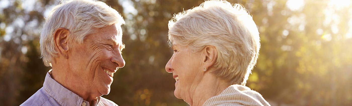 Senior couple smiling in the sunset average funeral costs