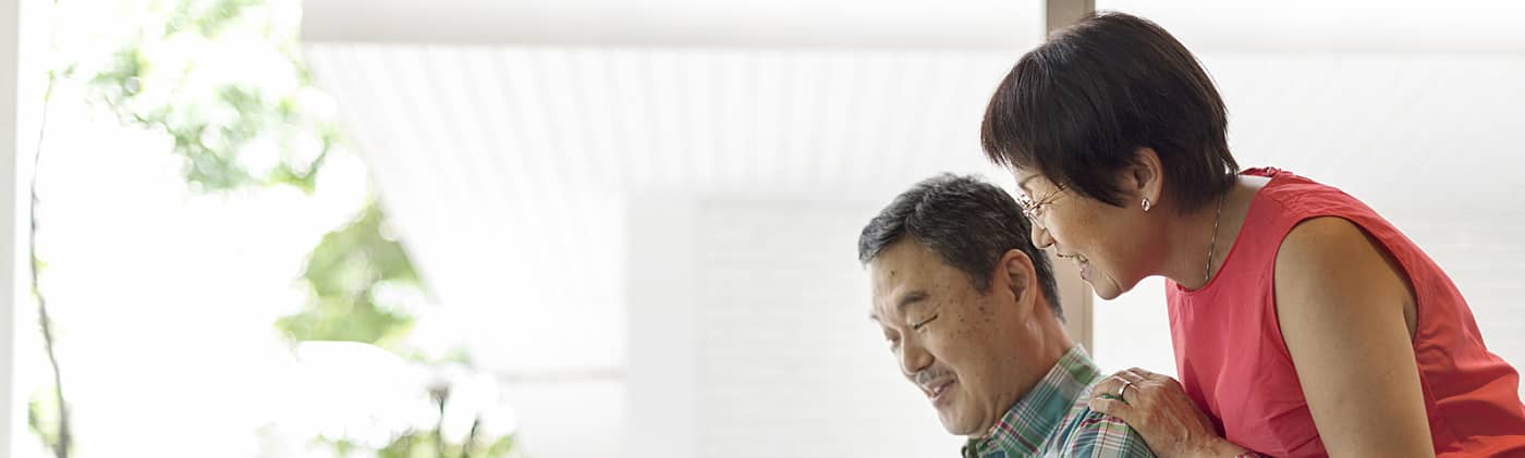 senior couple at home researches on laptop how to spot five common online life insurance scams