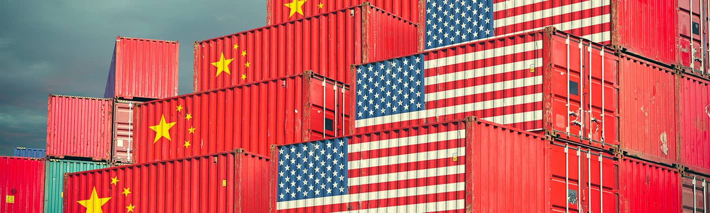 Shipping containers with US and China flags