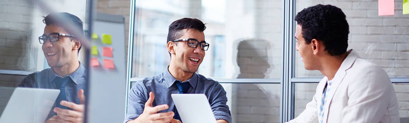 Small business owner and employee discussing employer open enrollment 