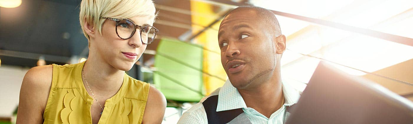 Small business owner speaking with one of his employees business launch