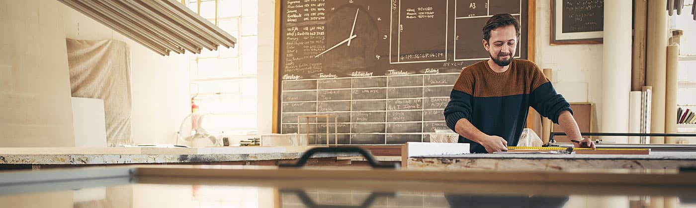 Small business owner at work after conducting an end-of-year business finance review in his workshop 