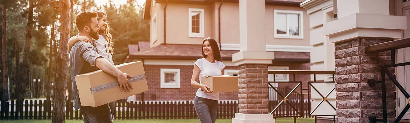 parents carry boxes into home with daughter and balance paying off student loan debt and buying a house