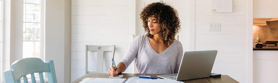 Tax Season Woman Organizing Paperwork Working Online