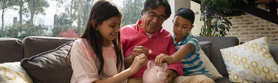 Grandfather teaching children financial literacy