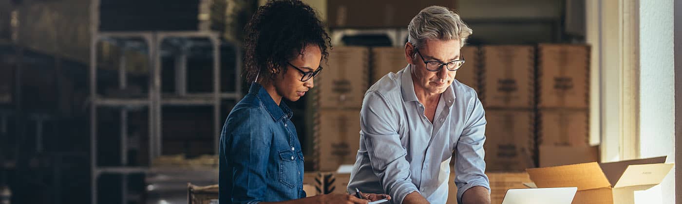 Two business partners work and discuss how to transfer business ownership 