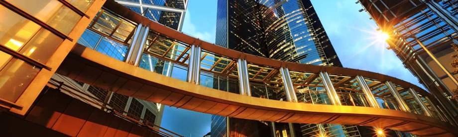 winding bridge under skyscrapers