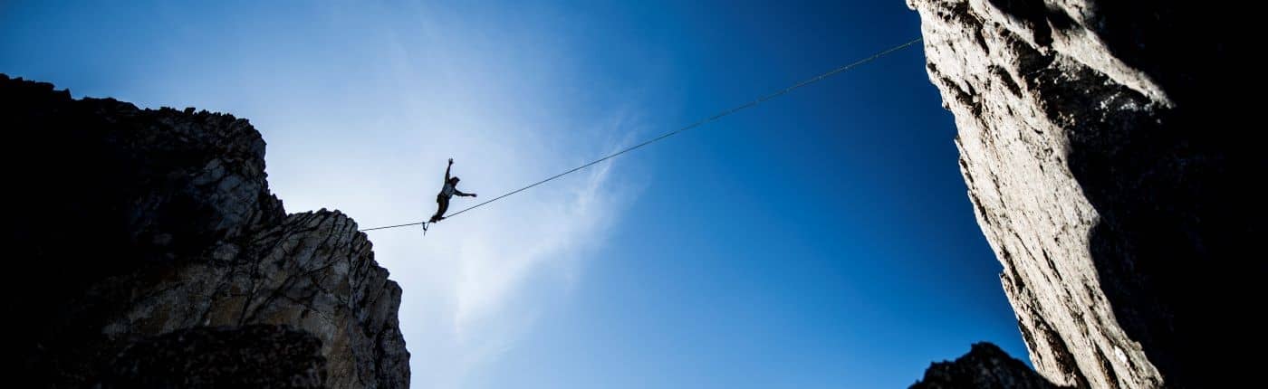 Tightrope walker high in the mountains.