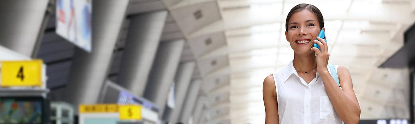 Woman speaks on her cellphone while walking through a busy airport: sabbatical