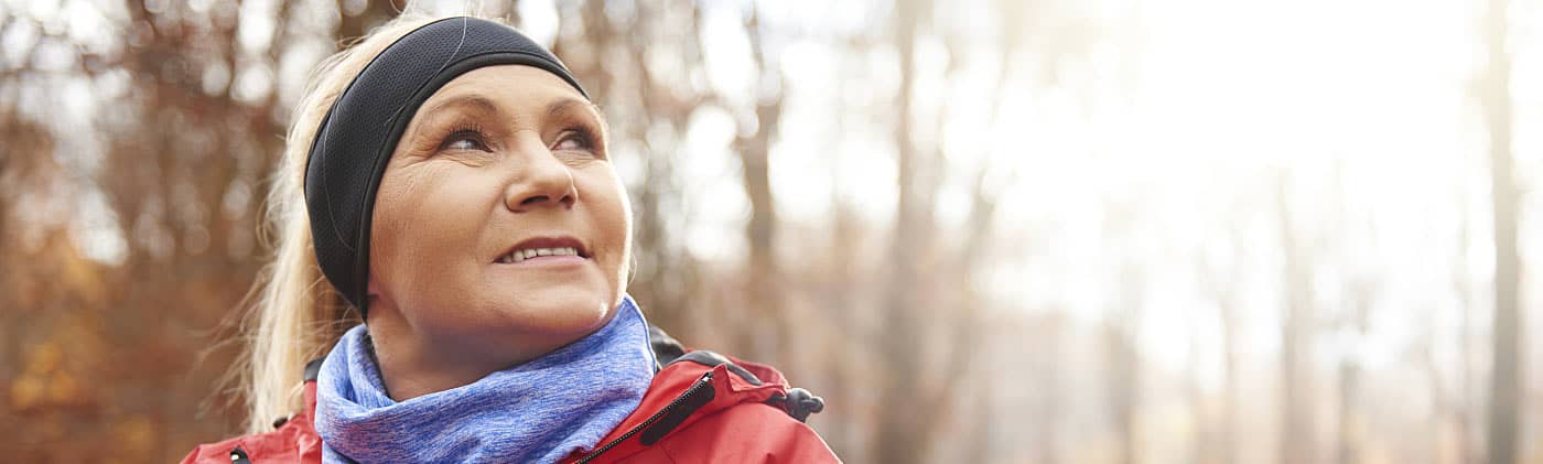 Woman zipping up coat on a run and thinking about how annuities work 