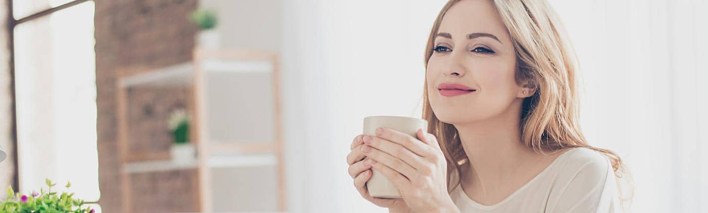 Young woman at her desk working toward a goal of early retirement: early retirement