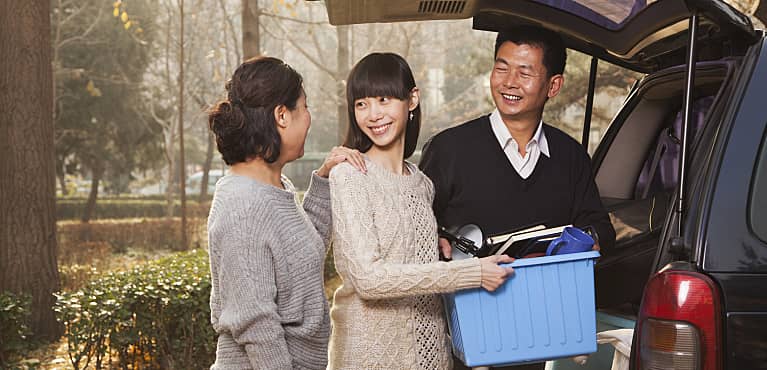 parents help adult daughter unload van and learn to balance their boomerang kid and retirement planning