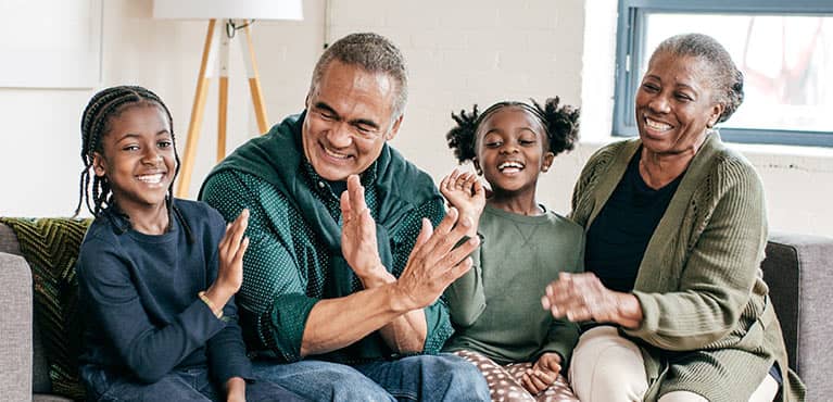 Grandparents enjoying time on the couch with the granddaughters
