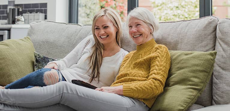 2 generations enjoying some time together on the couch