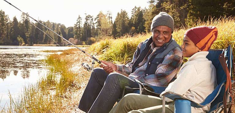 grandfather fishing with grandson after determining his reasons for life insurance 
