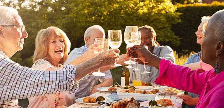 Group of coworkers toasting a recent retiree after planning retirement party ideas 