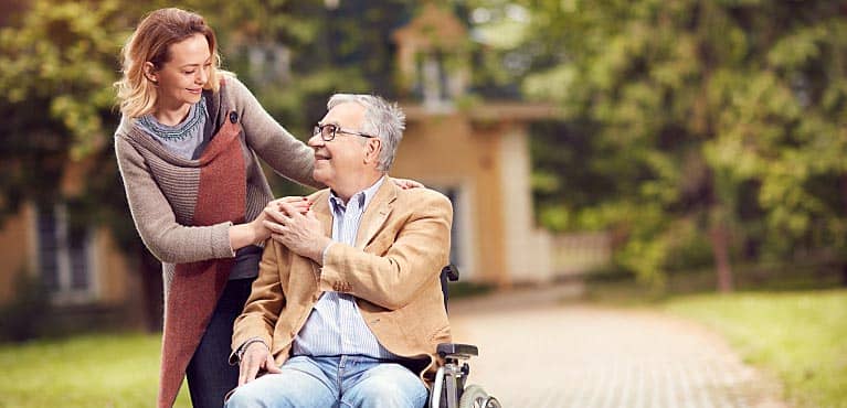 man in wheelchair asks caretaker daughter in a courtyard: what does critical illness insurance cover?