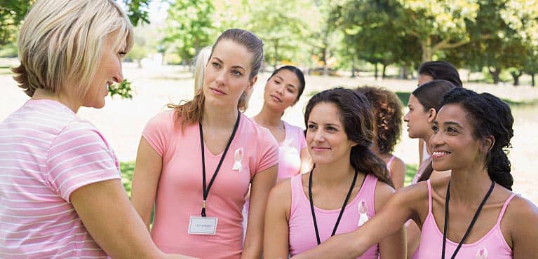 mature female volunteer leads charity event with young women and enjoys being a volunteer in retirement