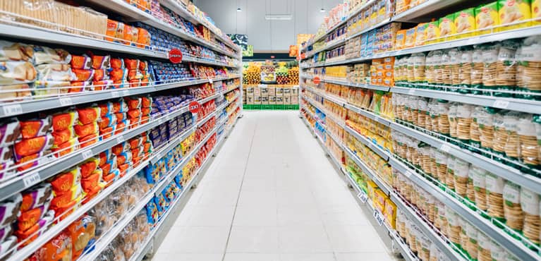 Grocery basket in grocery aisle