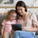 Mother and daughter using computer tablet together