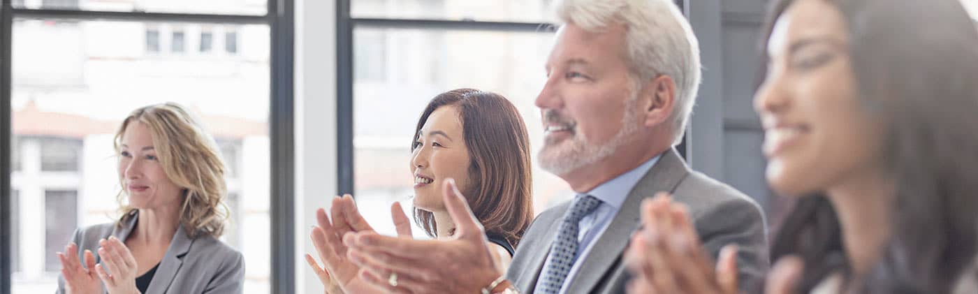 Clapping business people