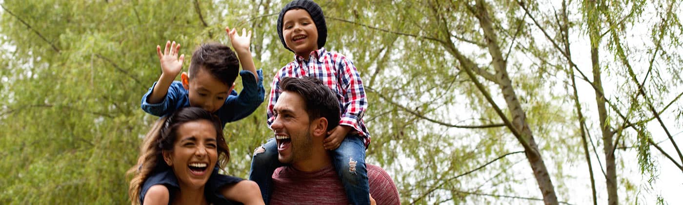 Kids on shoulders of mom and dad