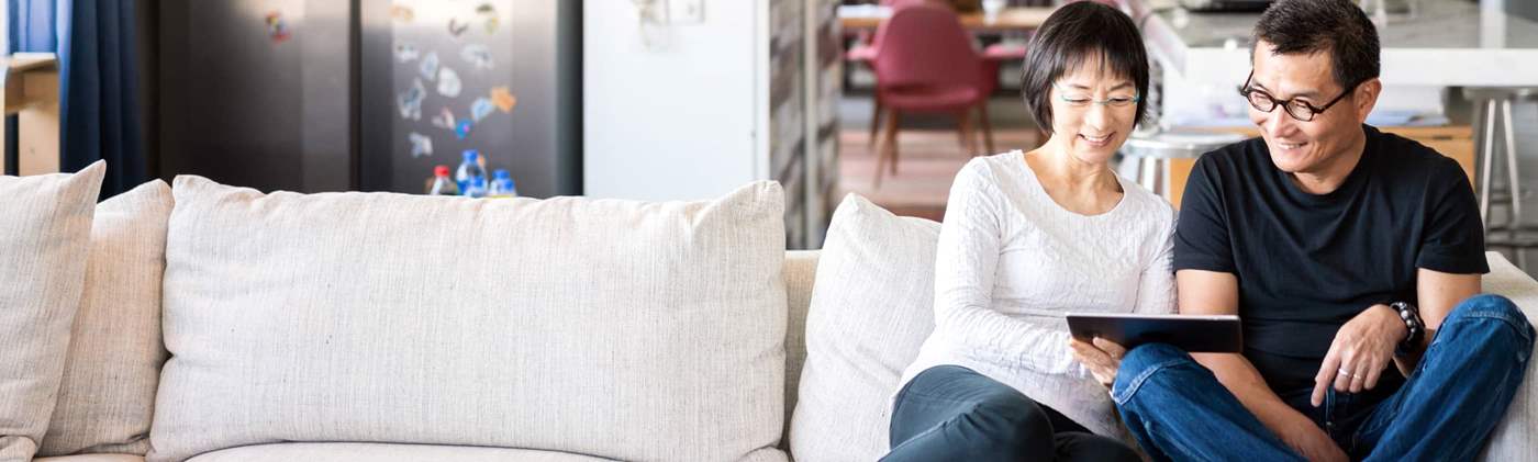 Couple on couch with tablet