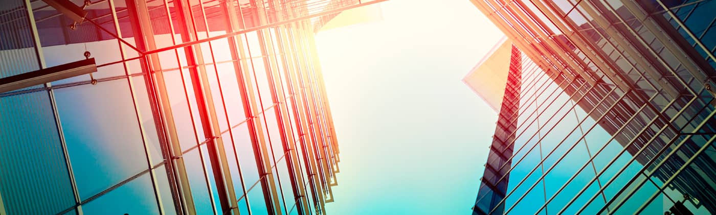 Sun shining above skyscrapers