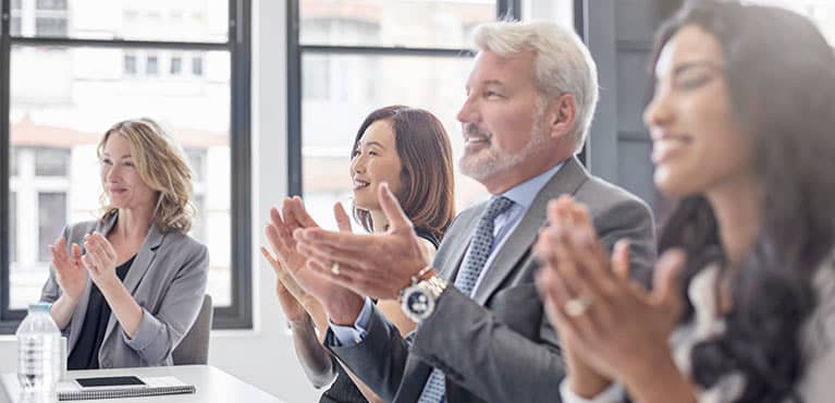 Clapping business people