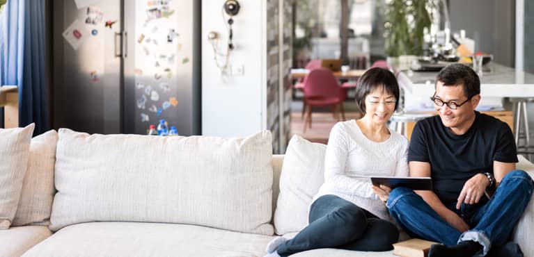 Couple on couch with tablet