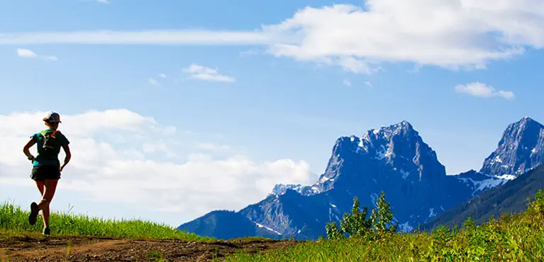 Runner approaching mountain range