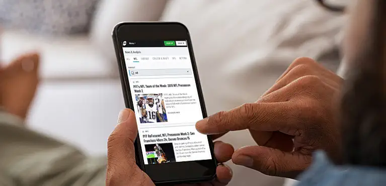 man looking at PFF app on cell phone