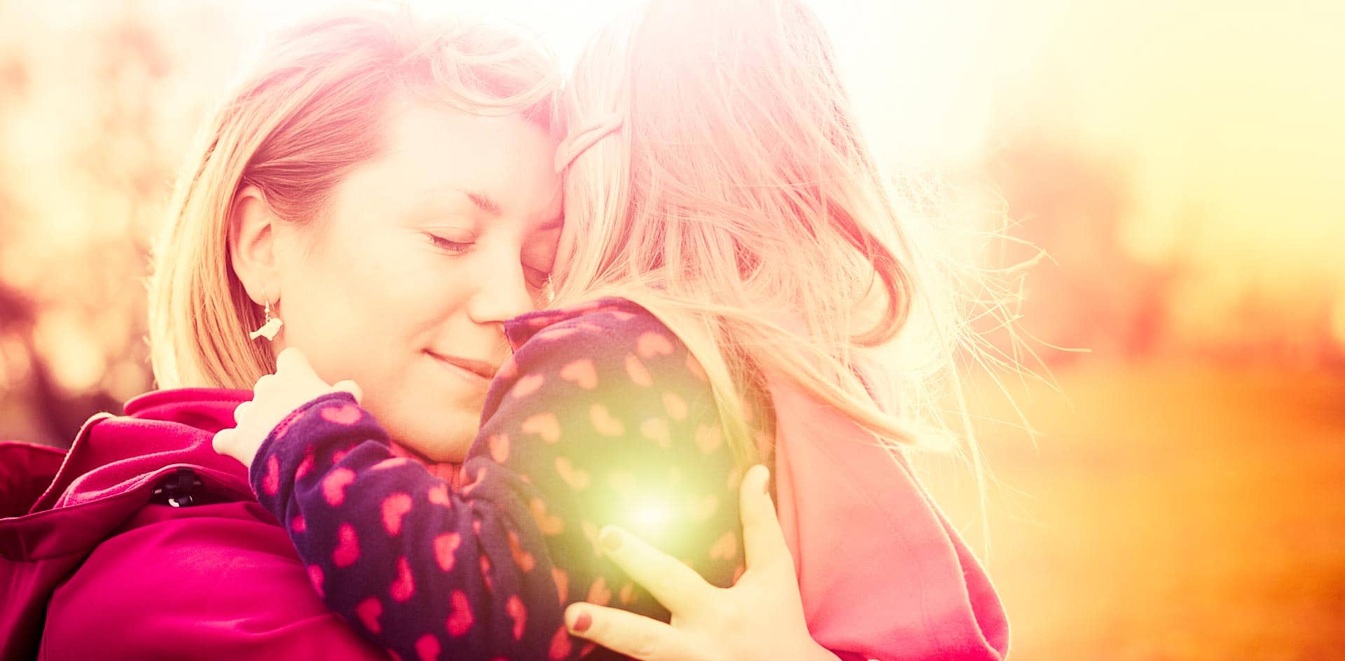 Mother and daughter hugging outside